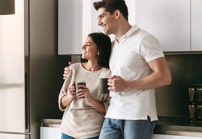 Couple in the kitchen enjoying coffee.
