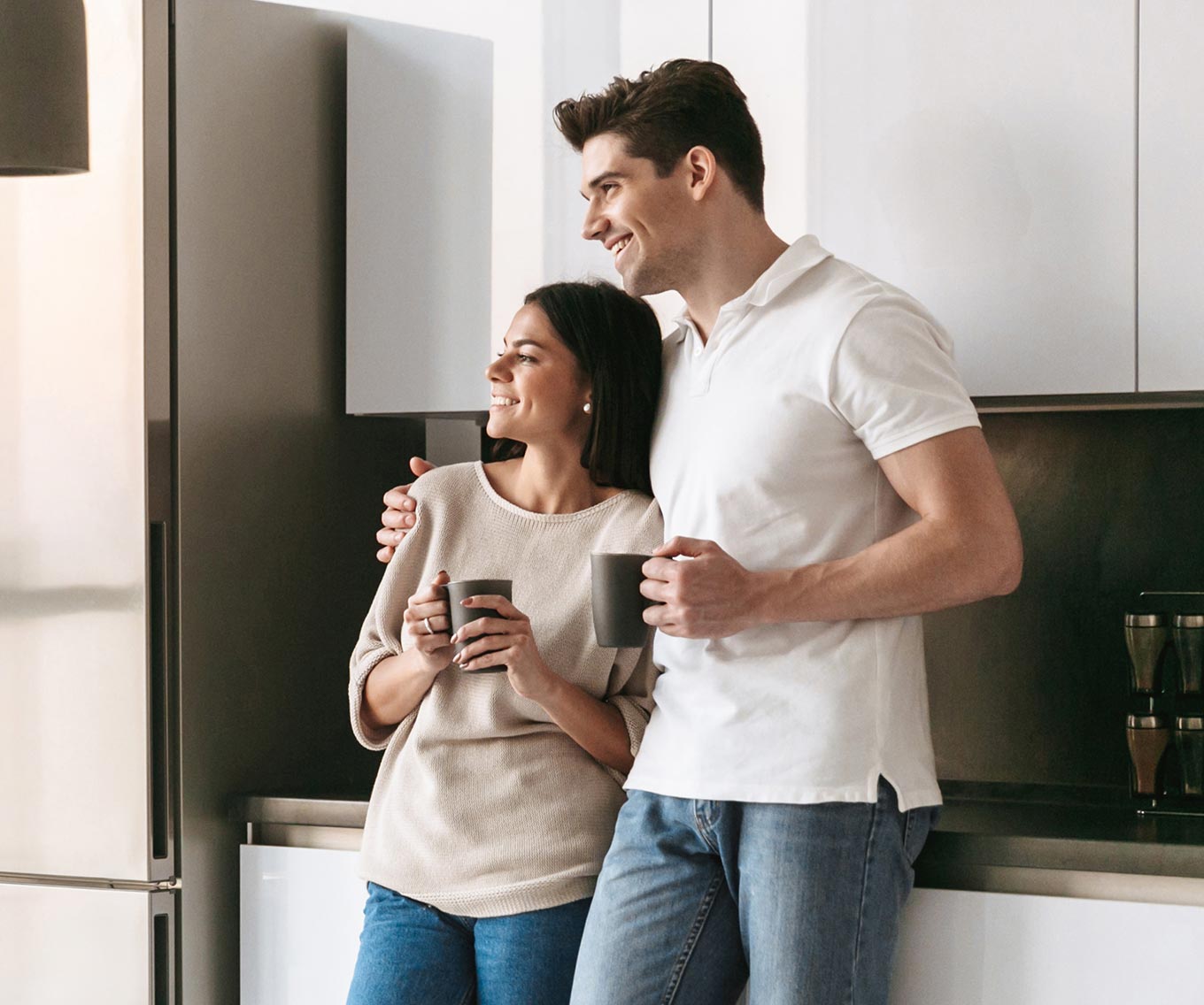 Couple in the kitchen enjoying coffee.