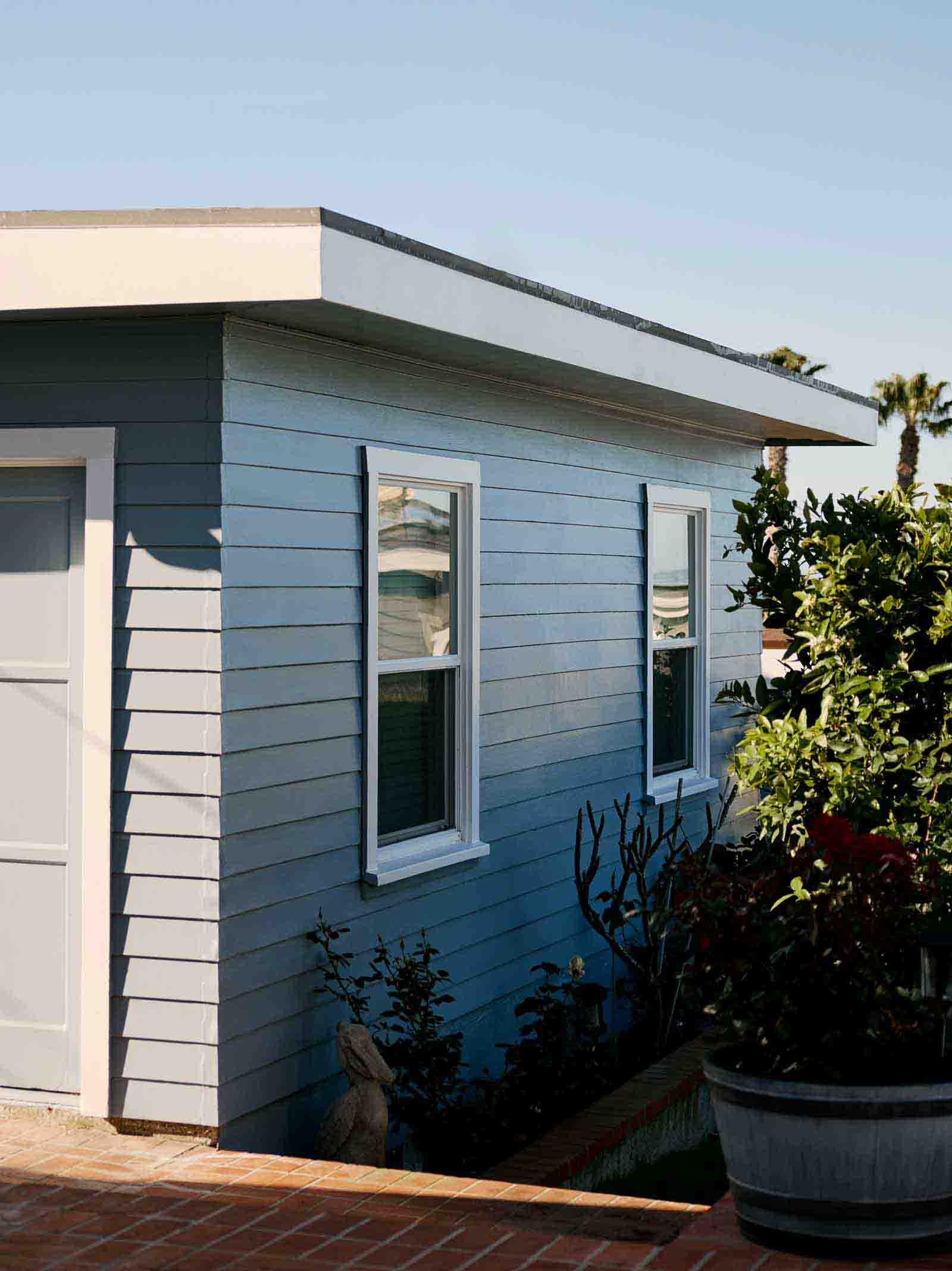 Entrance to a blue accessory dwelling unit (ADU) built behind primary residence.