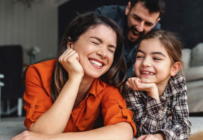 A family spending time together in the living room of their new home.
