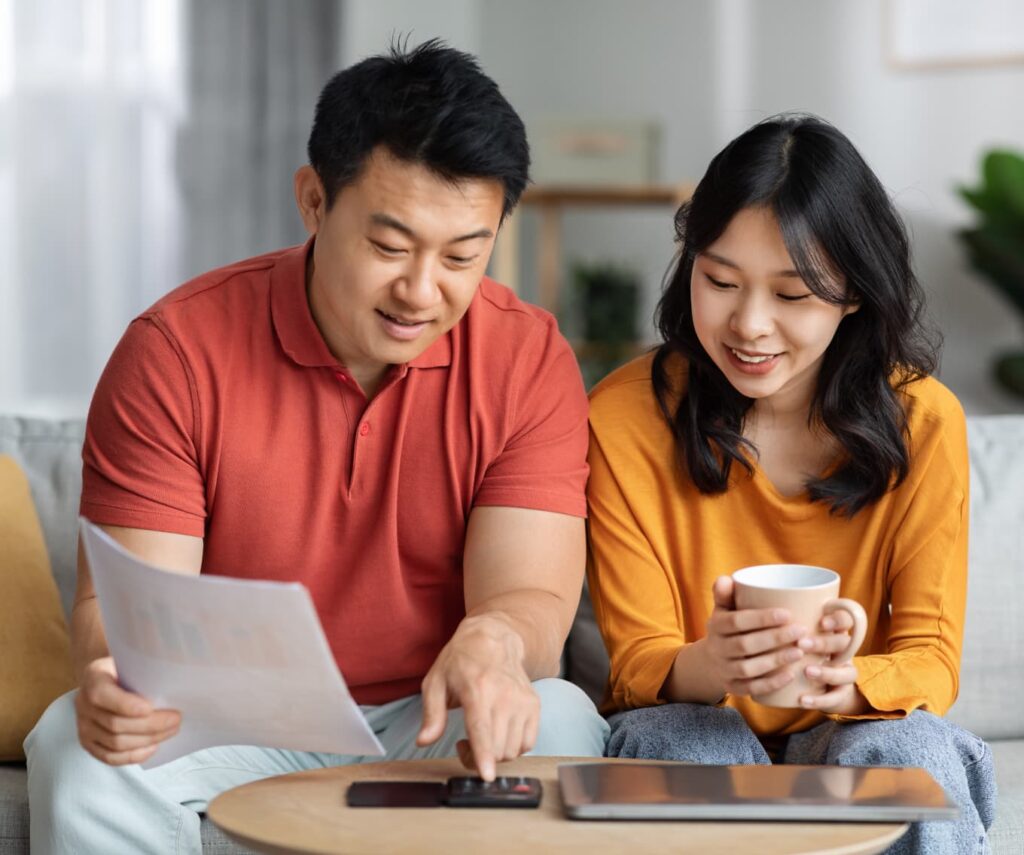First-time homebuyers calculating how much down payment is needed on a house.