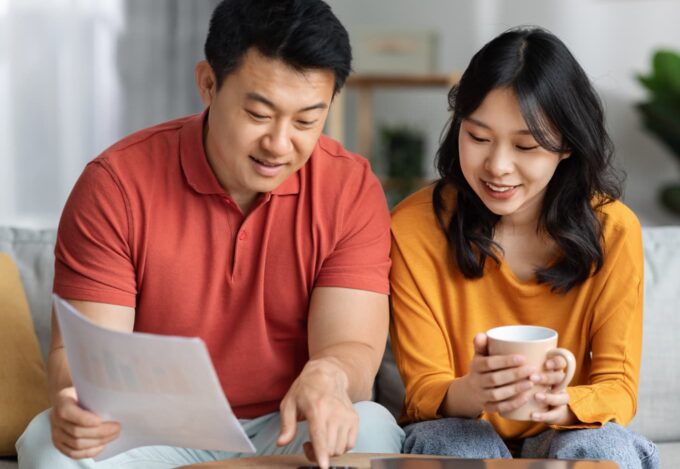 First-time homebuyers calculating how much down payment is needed on a house.