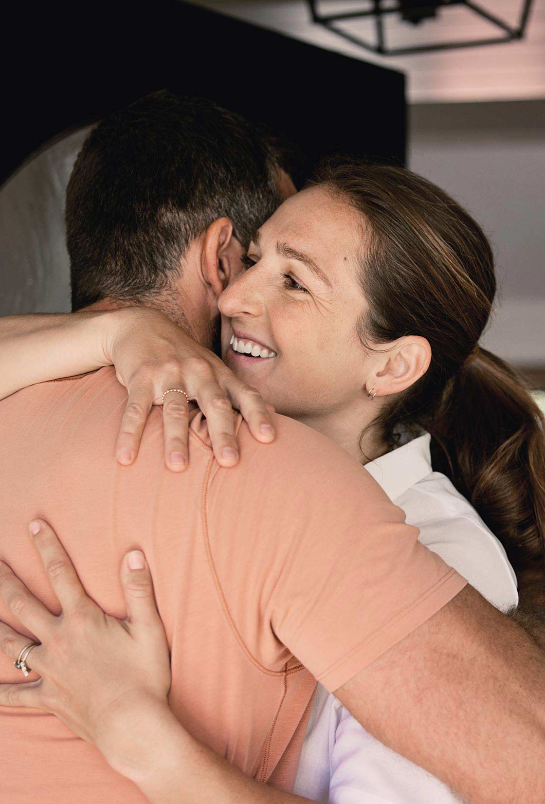 A young couple celebrate becoming homeowners thanks to different mortgage options for first-time homebuyers.