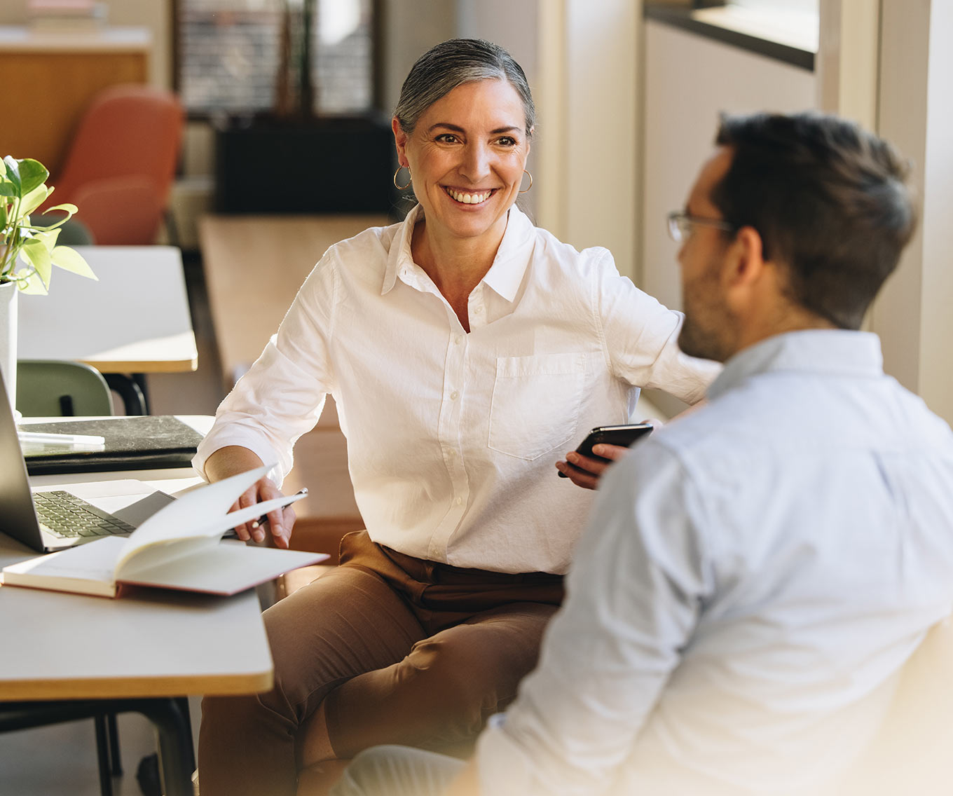 Two people talking about debt consolidation loans for bad credit.