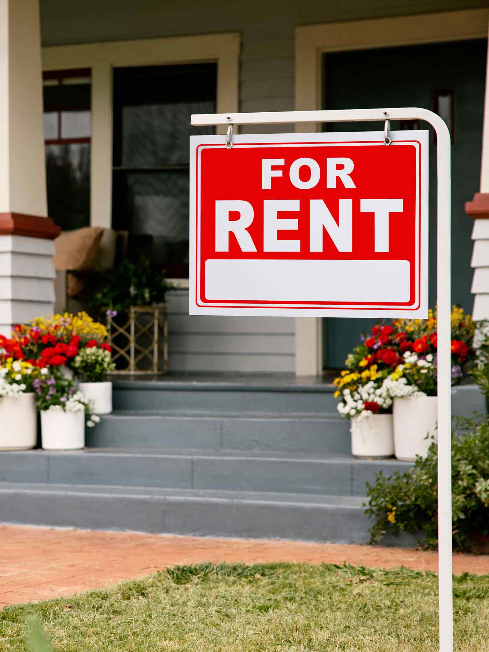 For sale sign shown outside of a duplex investment property available for purchase using DSCR loans.