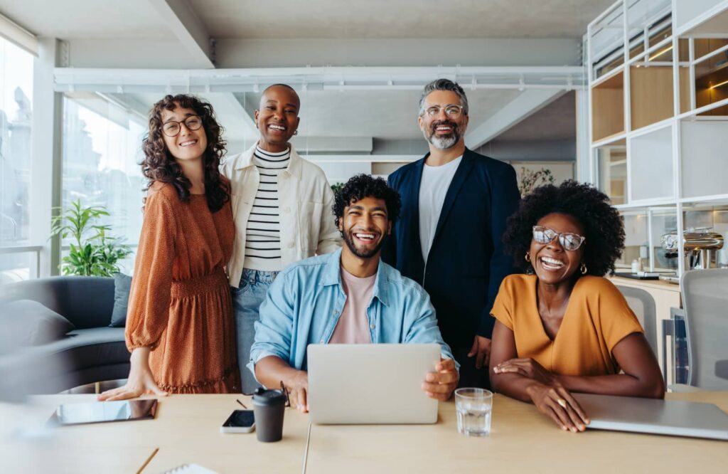 First-time homebuyers meet with real estate agent in office.