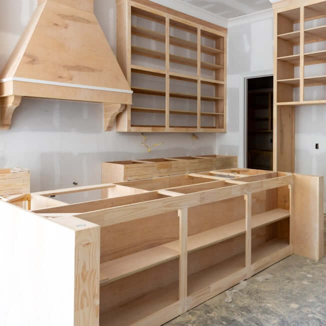 Kitchen cabinets being installed in a new kitchen as part of a new home being financed by a construction loan.