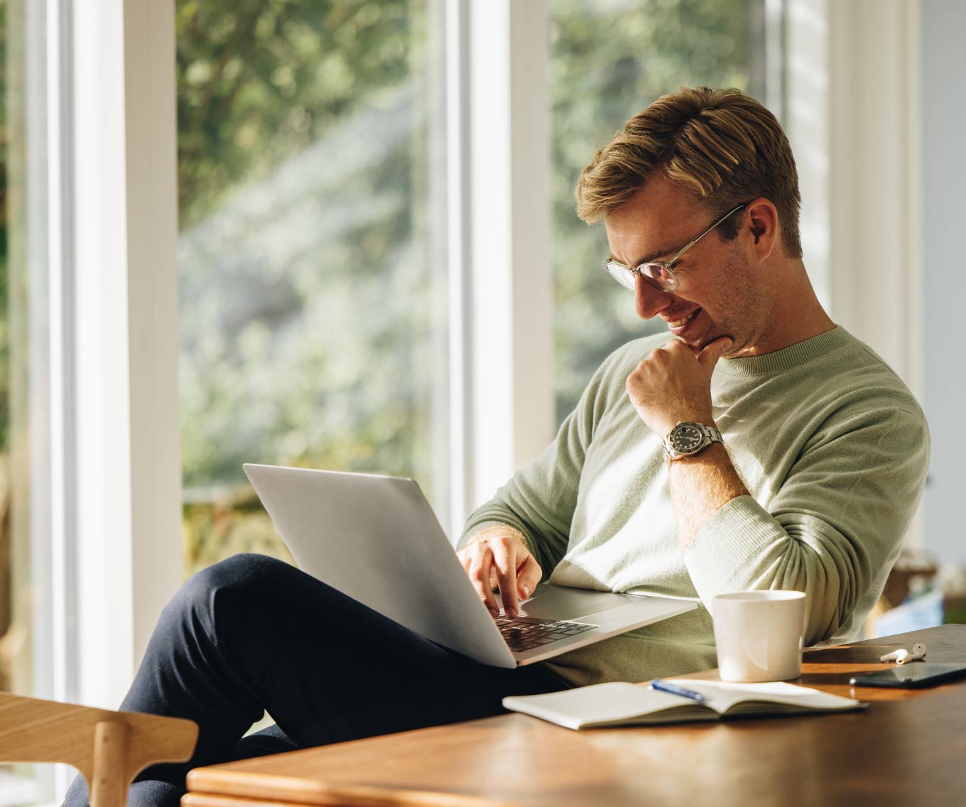 A renter researching on his laptop how he can buy his first home and become a homeowner.