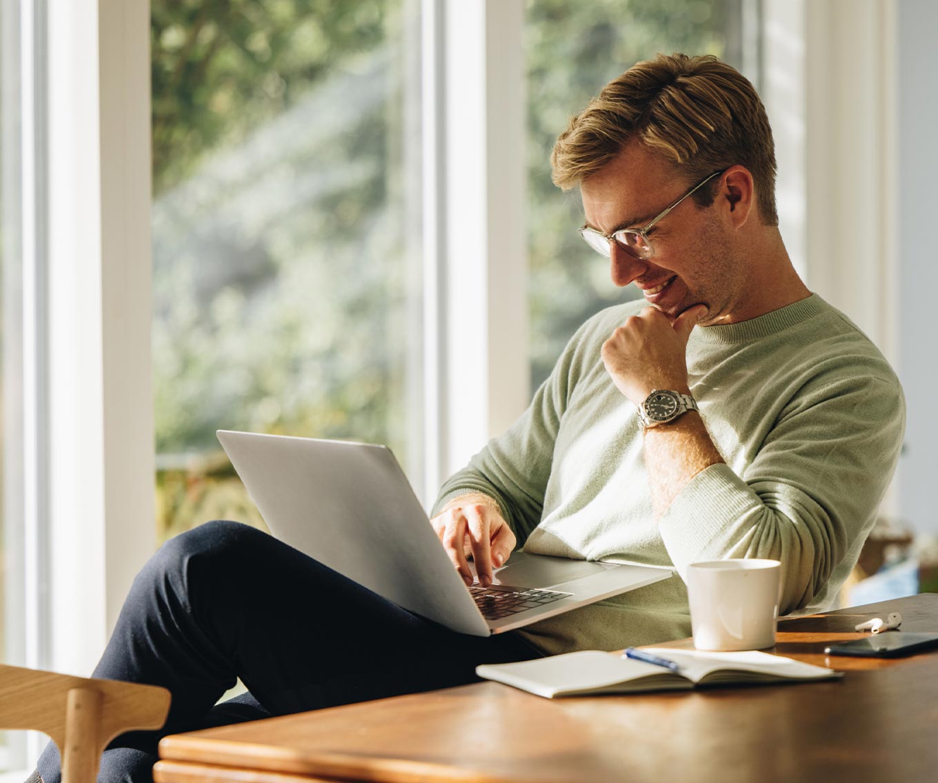Man uses laptop to find the right home in his real estate housing search.