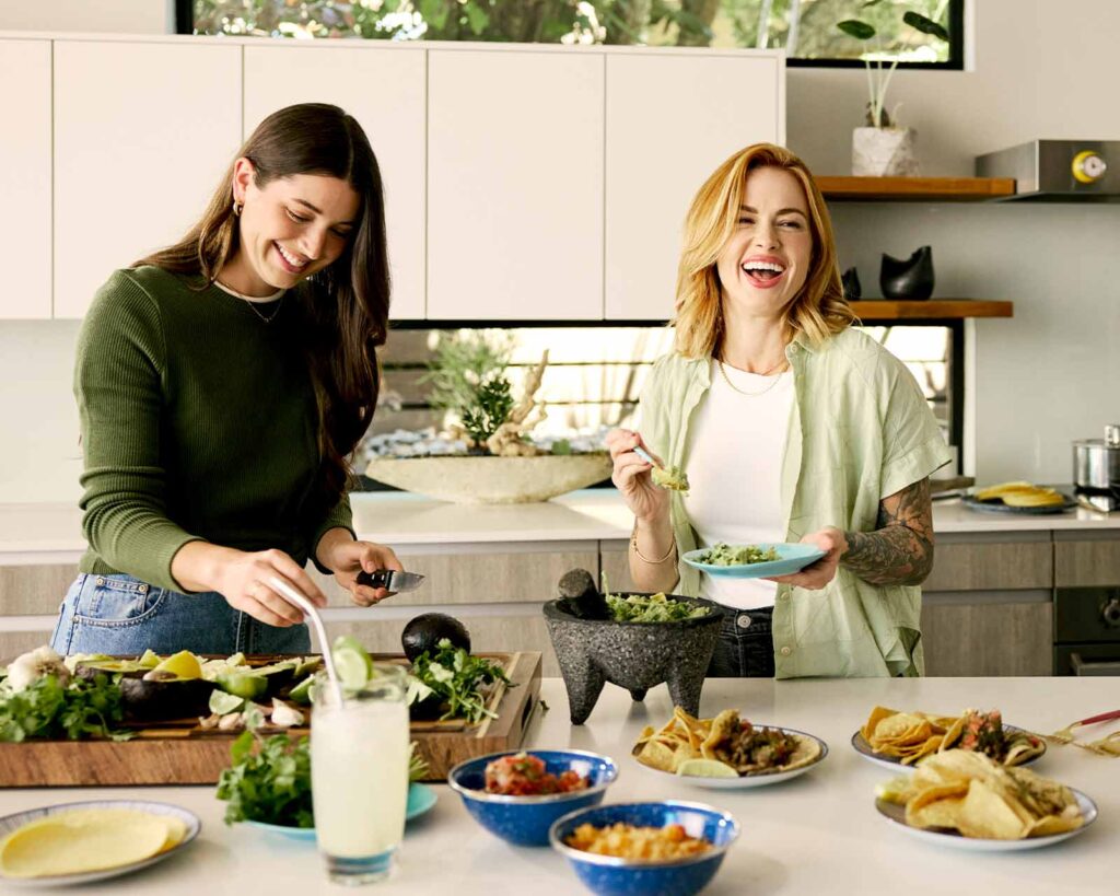 Modern home with multi-level deck including pool, landscaping and furniture.