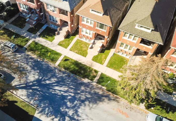 Exterior of street filled with owner-occupied, multi-family homes of 2-4 unit properties