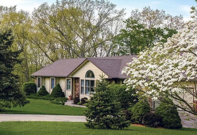 Exterior of a ranch style home whose mortgage is going through a refinance.