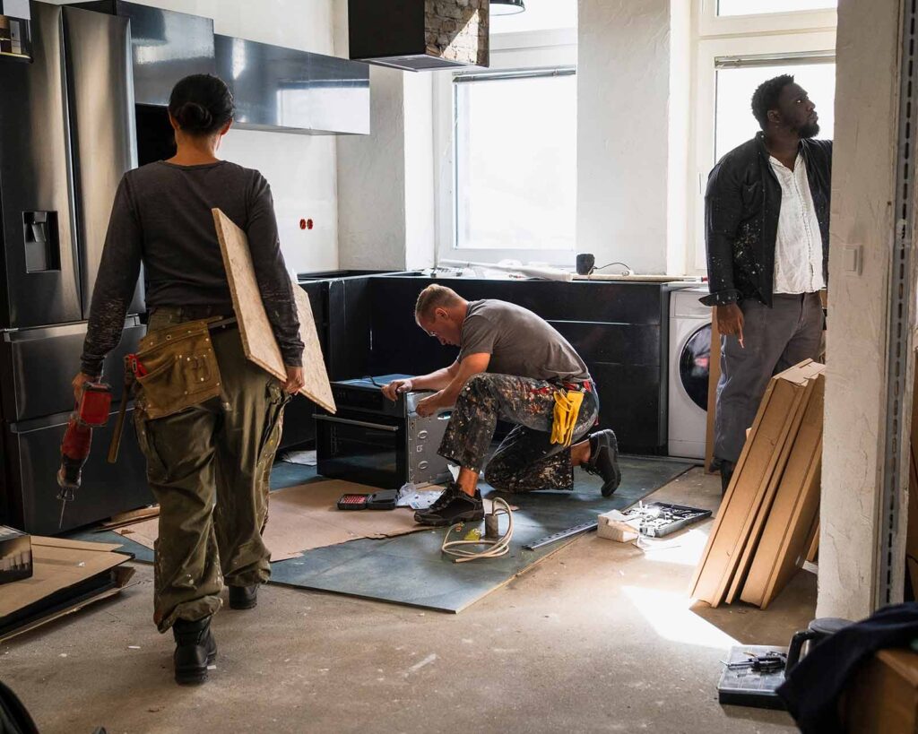 Renovation crew walks together outside of home improvement project financed using a renovation loan.