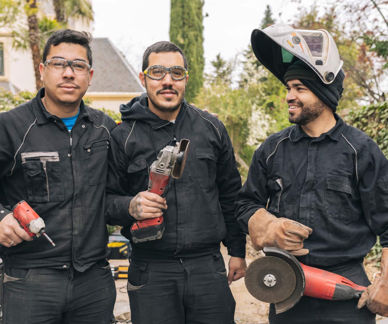 Three construction workers working outside on a house.