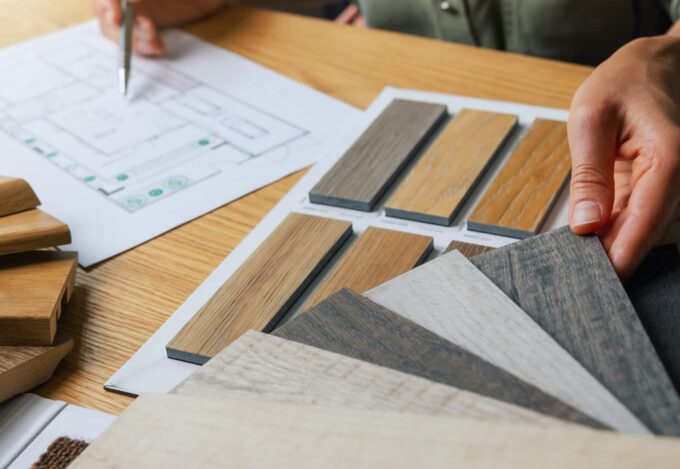 Person looking at home renovation plans and flooring options.