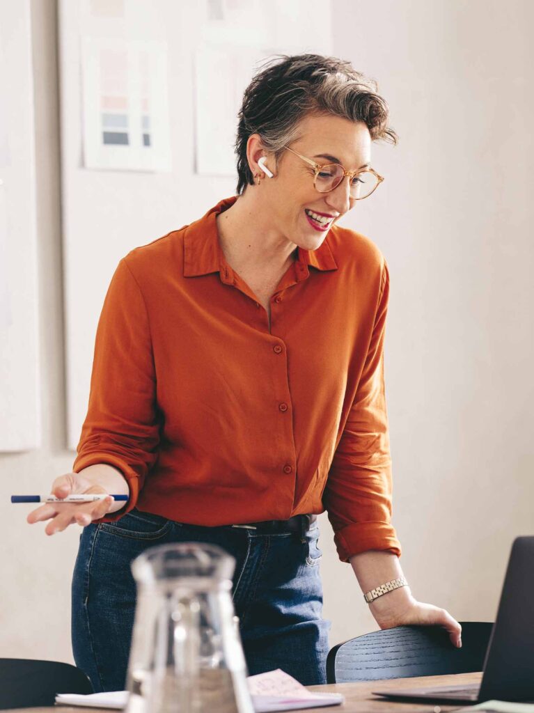 Woman at desk calculates her mortgage interest rate.