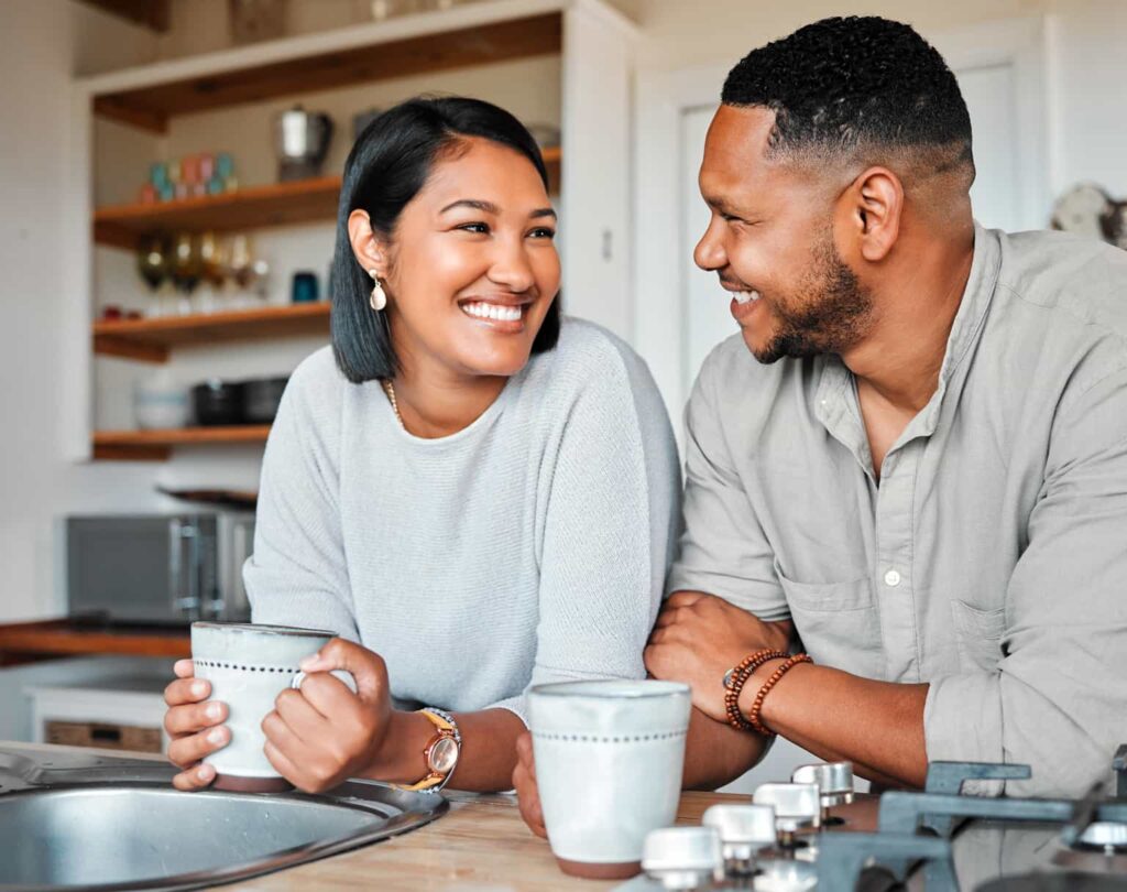 Couple drinking coffee in their first home