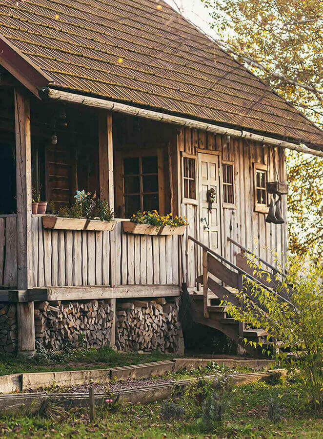 Exterior of a wooden cabin-style home renovated using a USDA renovation loan. 